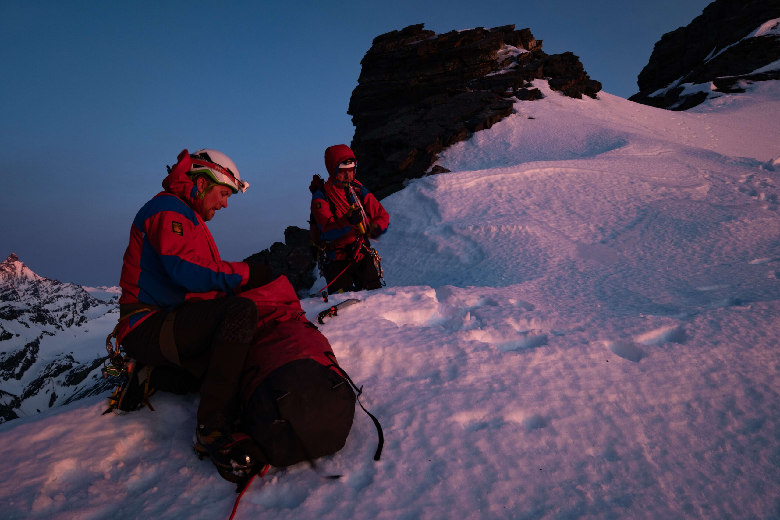 Sunset mountain climb in the snow in Paramo jacket